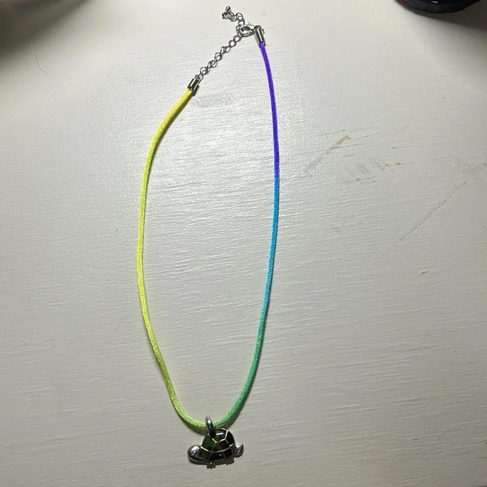 Kids 16” nylon ombré necklace with a silver turtle pendant green accents. Used